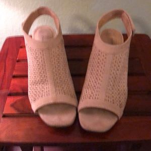 Tan , short heel with a Velcro strap shoe,